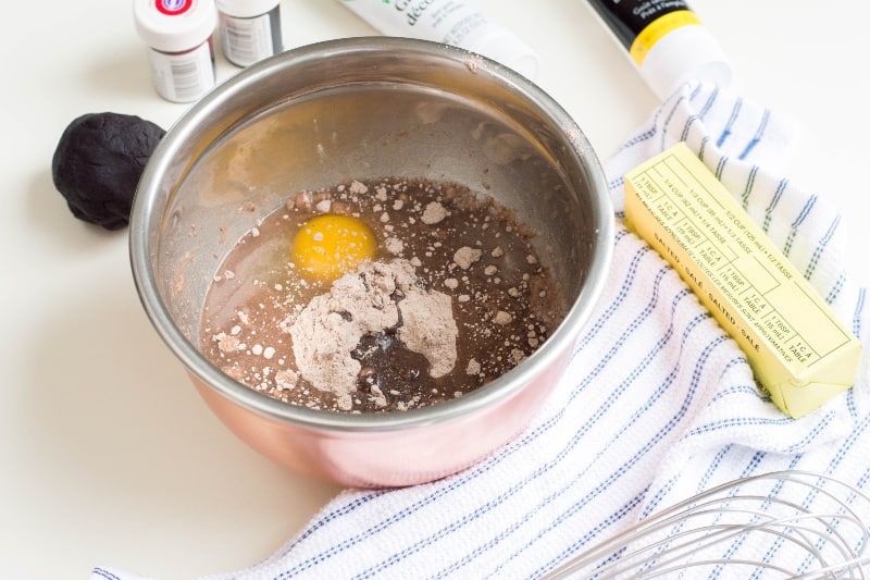 bowl with eggs, cake mix, and butter sitting on table