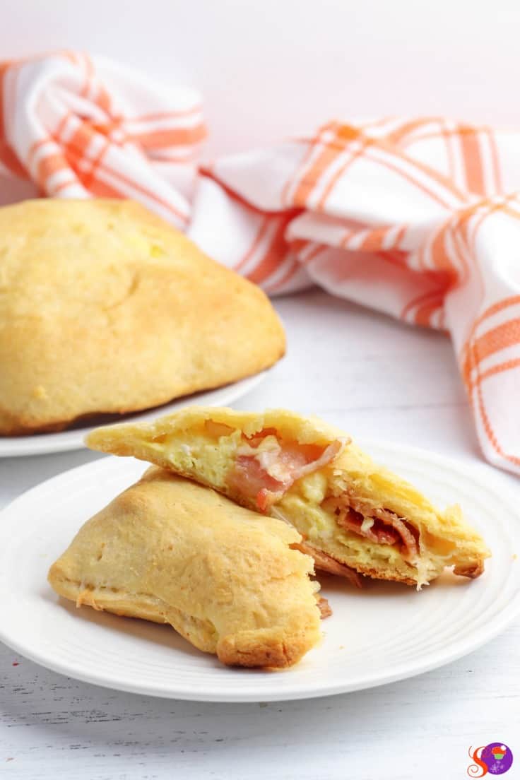 Bacon, Egg, and Cheese Breakfast Pockets are stuffed full of fluffy scrambled eggs, crispy bacon, and melted cheese wrapped up and baked in light and flaky canned crescent roll dough. An easy and filling breakfast that you can take on-the-go!