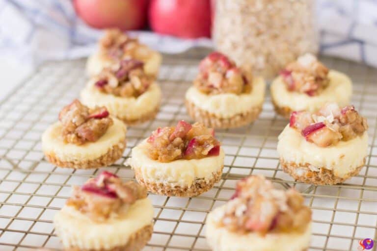 Mini Apple Crumble Cheesecakes on a cooling rack.
