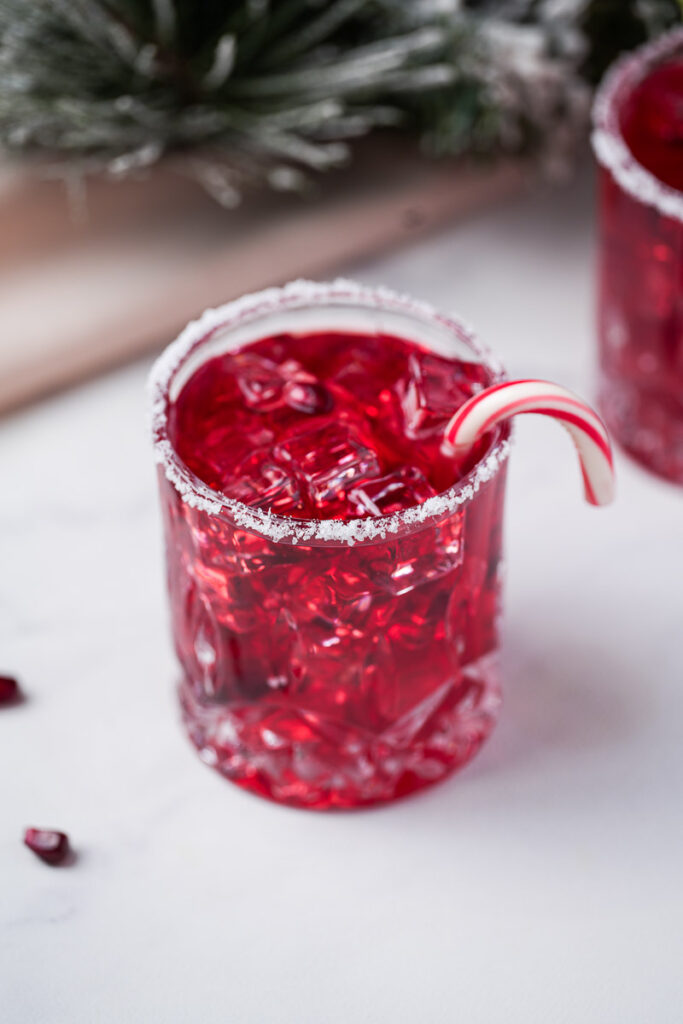 Naughty Elf Cocktail with candy cane close-up