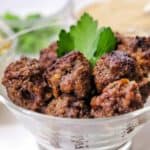 meatballs sitting in a clear bowl on table