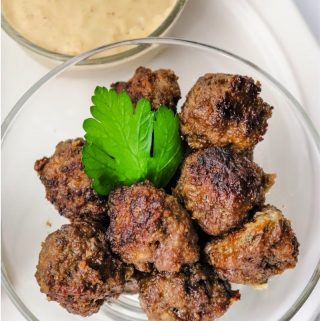 Meatballs in a bowl with Swedish Meatball Gravy on the side