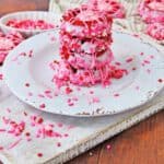 pink decorated cookies sitting on plate