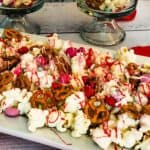 Valentine’s Day Snack Popcorn on a white plate with glasses in the back