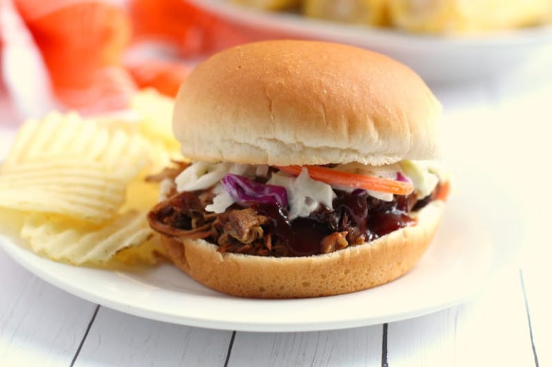 Crock-Pot Texas-Style Pulled Pork on a bun on a white plate