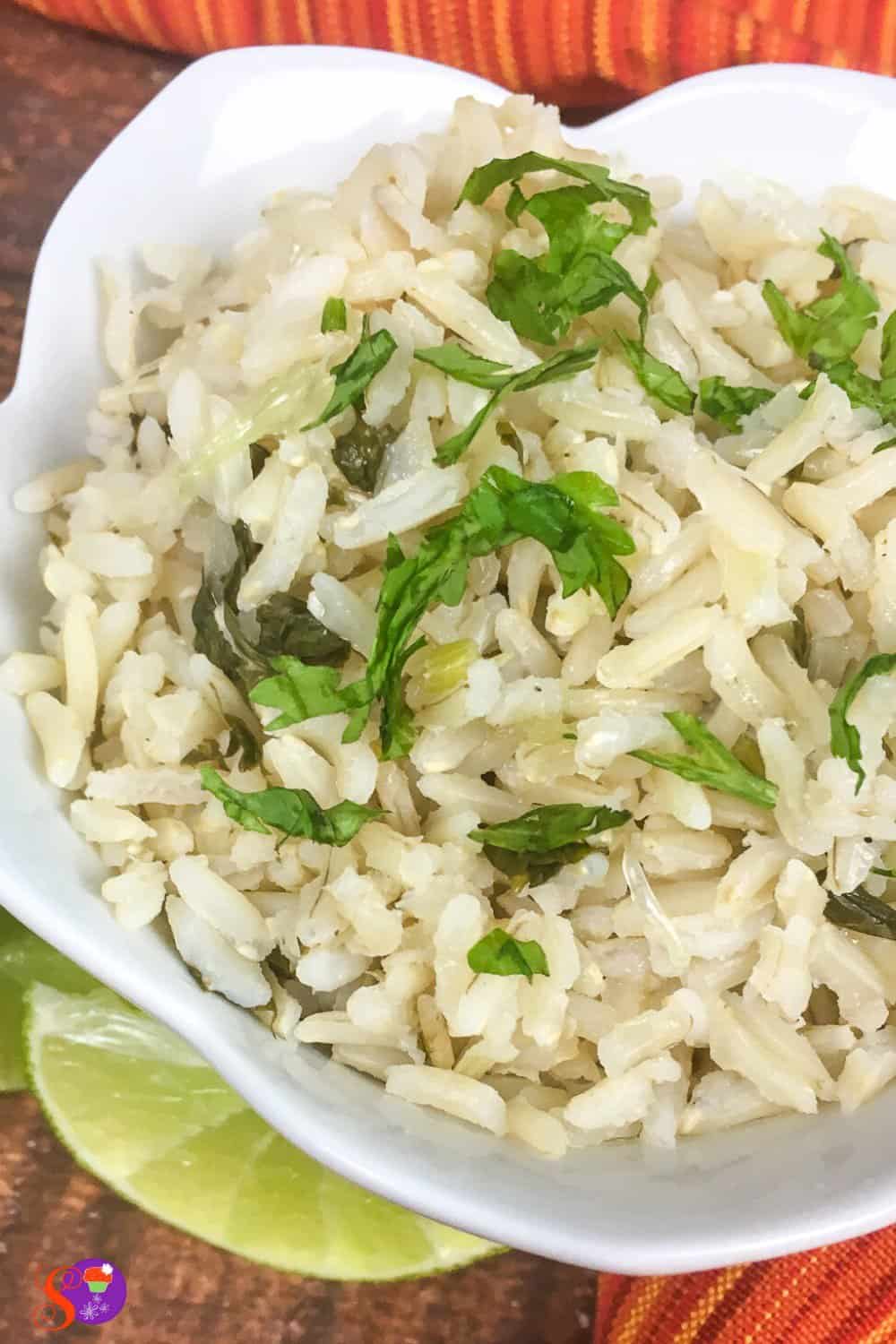 Brown rice is flavored with fresh lime juice, lime zest, garlic, and cilantro in this simple Cilantro Lime Rice recipe!
