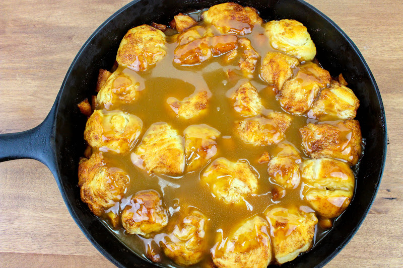 Pan of caramel apple pull apart bread, featuring pieces of dough coated in rich caramel sauce and layered with juicy apple bits.