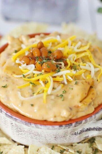 Crock pot taco queso in plate with chips.