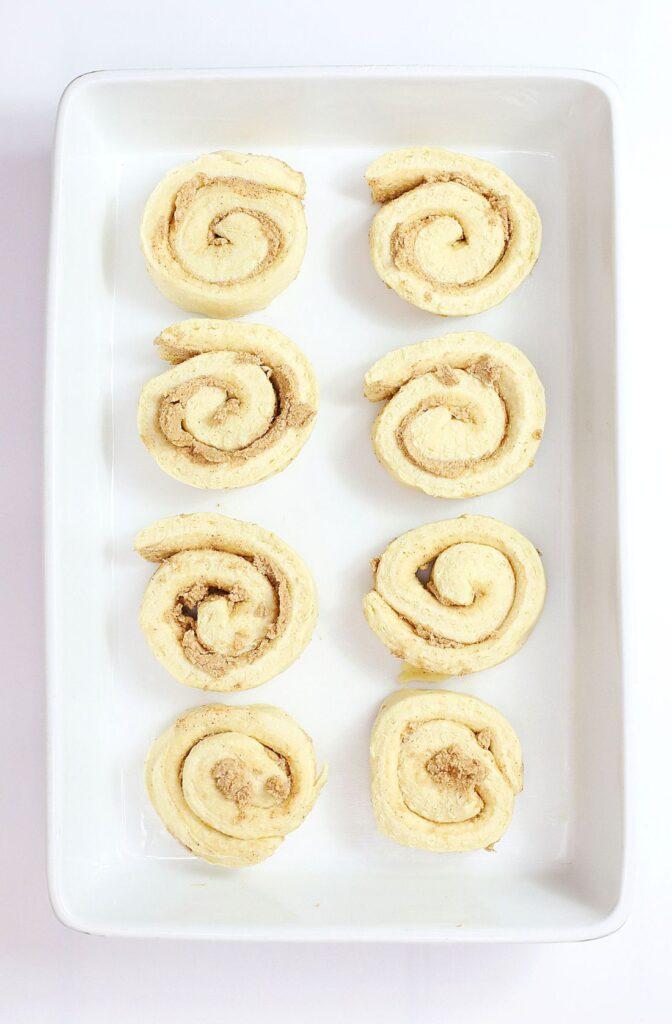 Frosty's Meltdown: Irresistible Melted Snowman Cinnamon Rolls 4 Snowman Cinnamon Rolls in a pan