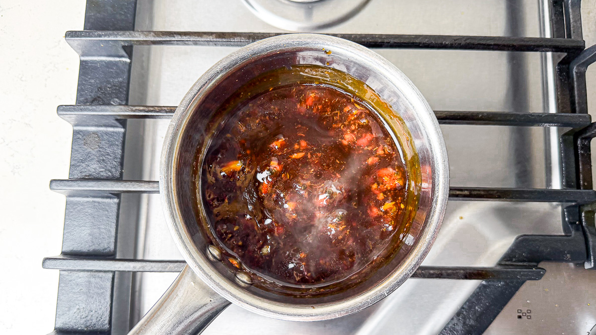 Teriyaki sauce boiling in saucepan on stovetop