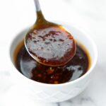homemade teriyaki sauce in bowl dripping from spoon