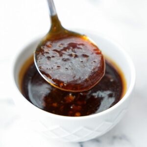 homemade teriyaki sauce in bowl dripping from spoon