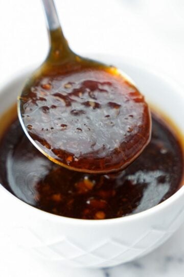 homemade teriyaki sauce in bowl dripping from spoon