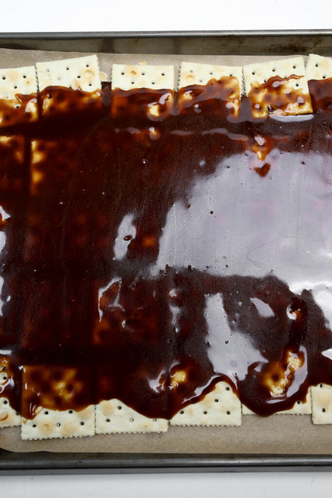 Glitter Valentine's Cracker Candy: A Sweet & Sparkly Treat 8 A tray of Valentine's Cracker Candy is partially covered with a thick layer of rich brown sauce, creating an enticing treat.