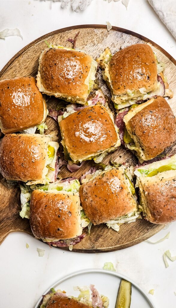 Easy Italian Sliders Recipe 14 A wooden board showcases nine Italian sliders.