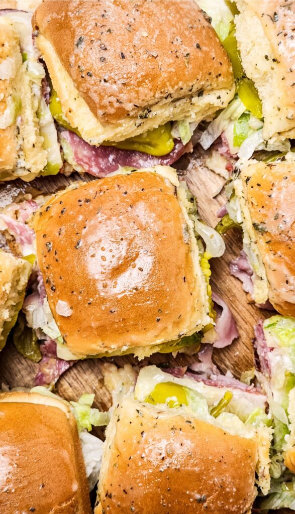 Easy Italian Sliders Recipe 12 Close-up of several Italian sliders filled with crisp lettuce and sliced meats. Perfect for a quick bite or party platter, this easy Italian sliders recipe brings a touch of Italian flair to your table.
