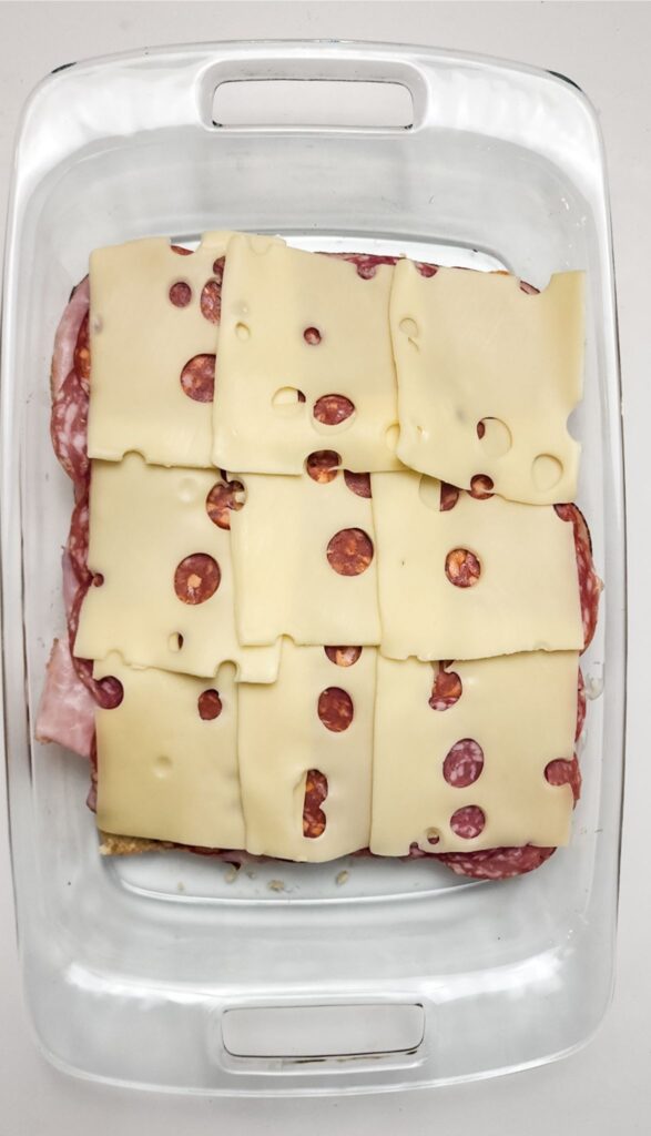 Easy Italian Sliders Recipe 5 Layer the cheese on top of the ham, salami, and pepperoni.