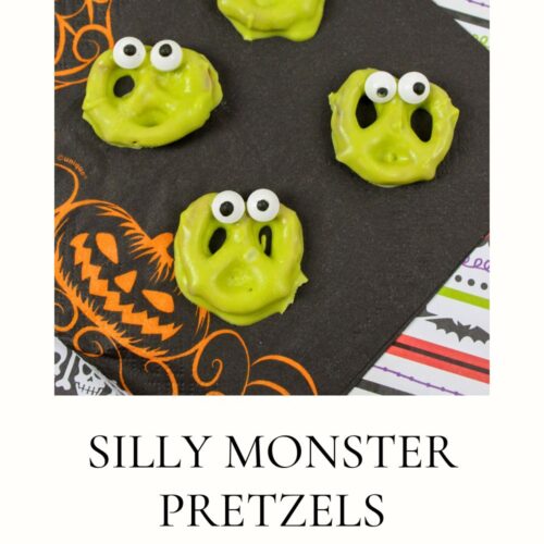 Four green pretzels with googly eyes are on a black napkin with Halloween designs. Text reads, "Silly Monster Pretzels.