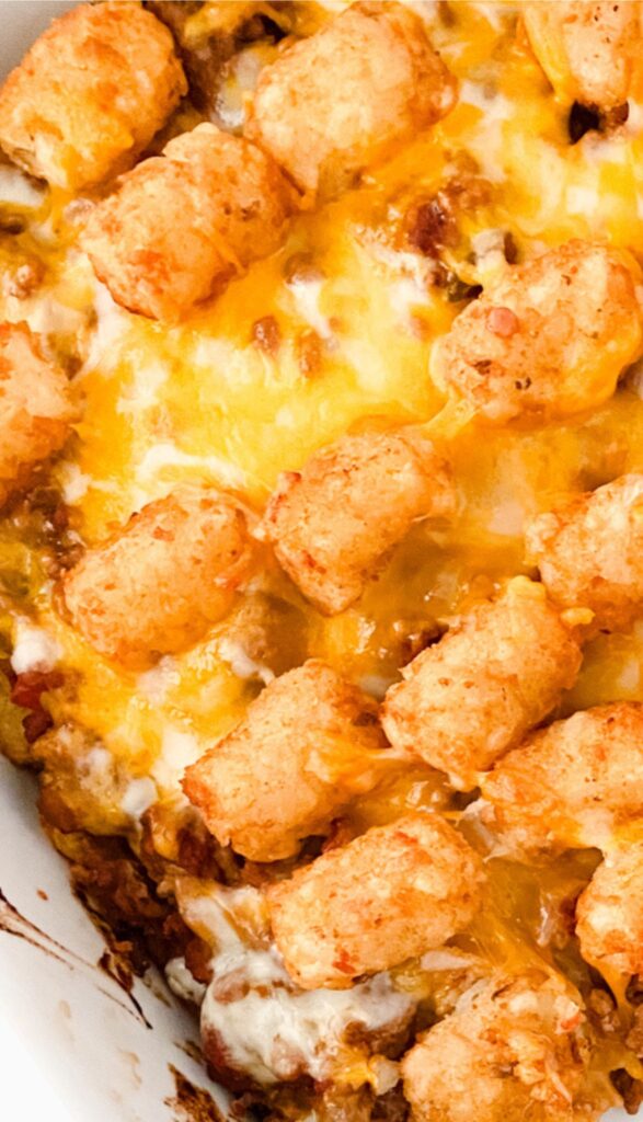 Taco Tot Casserole topped with crispy tater tots and melted cheese in a baking dish.