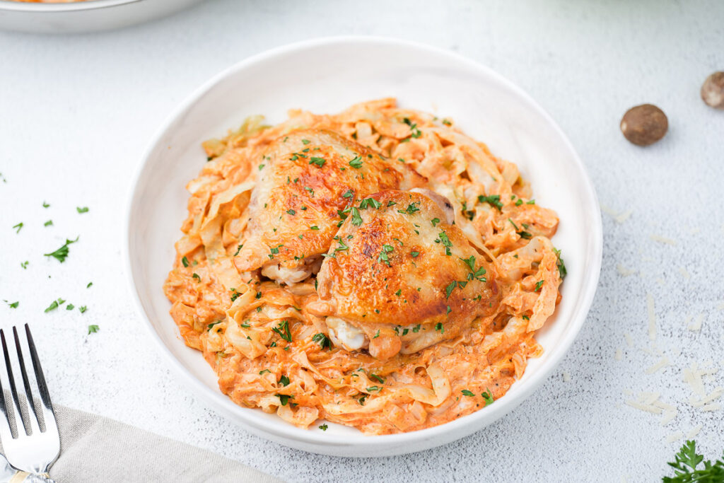Creamy Cabbage Alfredo with Crispy Chicken Thighs (A Low-Carb Comfort Dinner) 1 Creamy Cabbage Alfredo in a dish on table