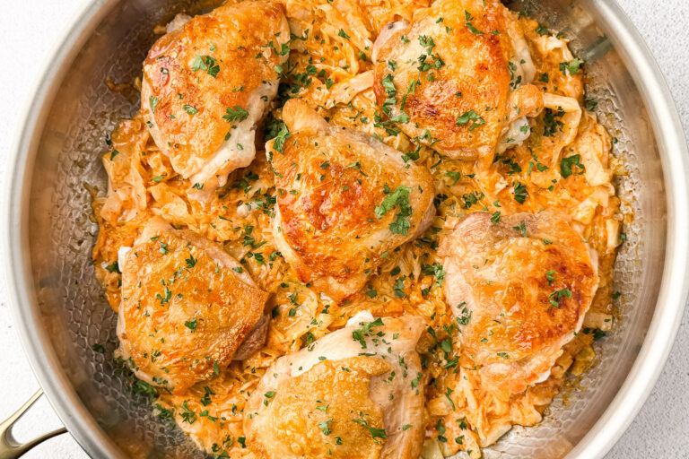 Creamy Cabbage Alfredo with Crispy Chicken Thighs (A Low-Carb Comfort Dinner) 19 chicken thighs in pan on top of cabbage alfredo sauce