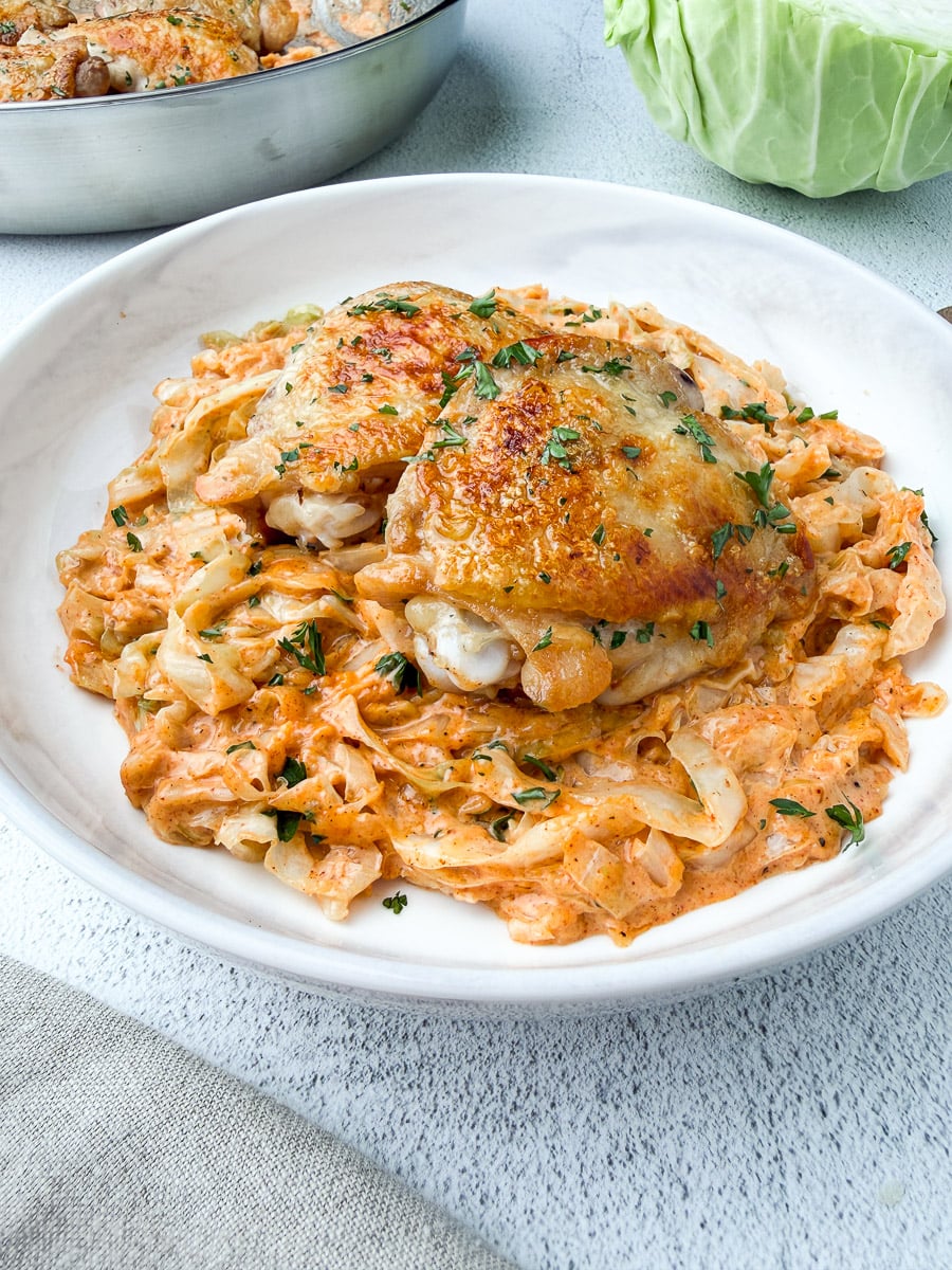 chicken thighs on top of cabbage alfredo