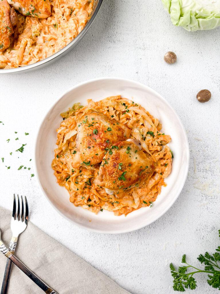 Creamy Cabbage Alfredo with Crispy Chicken Thighs (A Low-Carb Comfort Dinner) 11 creamy cabbage alfredo recipe plate with on table with fork