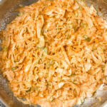 creamy cabbage alfredo sauce in titanium pan