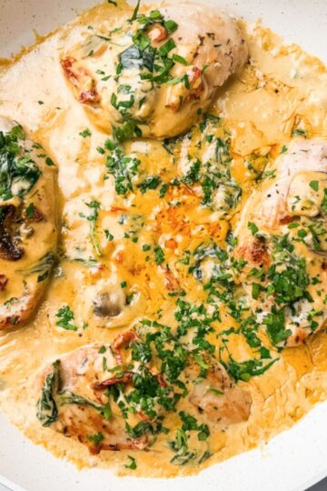 creamy tuscan chicken in white pan