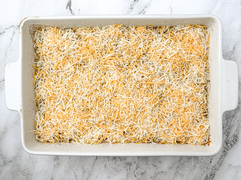 ground beef and rice casserole with shredded cheese on top