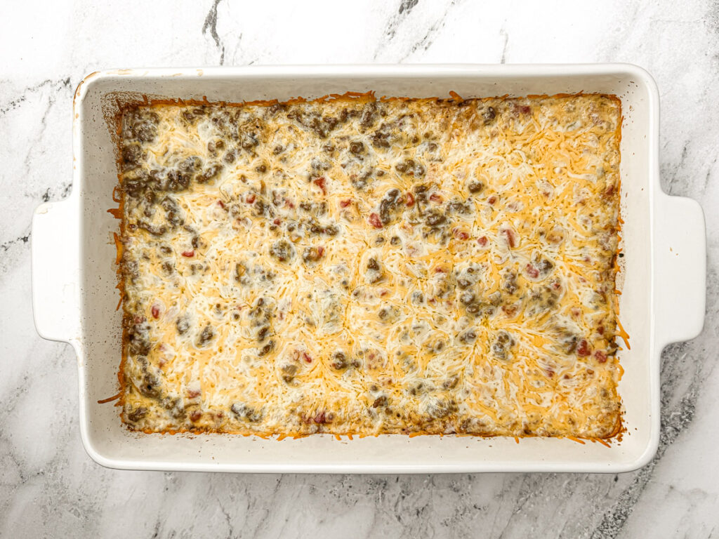 cooked ground beef and rice casserole with melted cheese on top