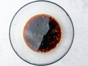 Bowl of honey garlic soy sayce and chicken broth marinade mixture