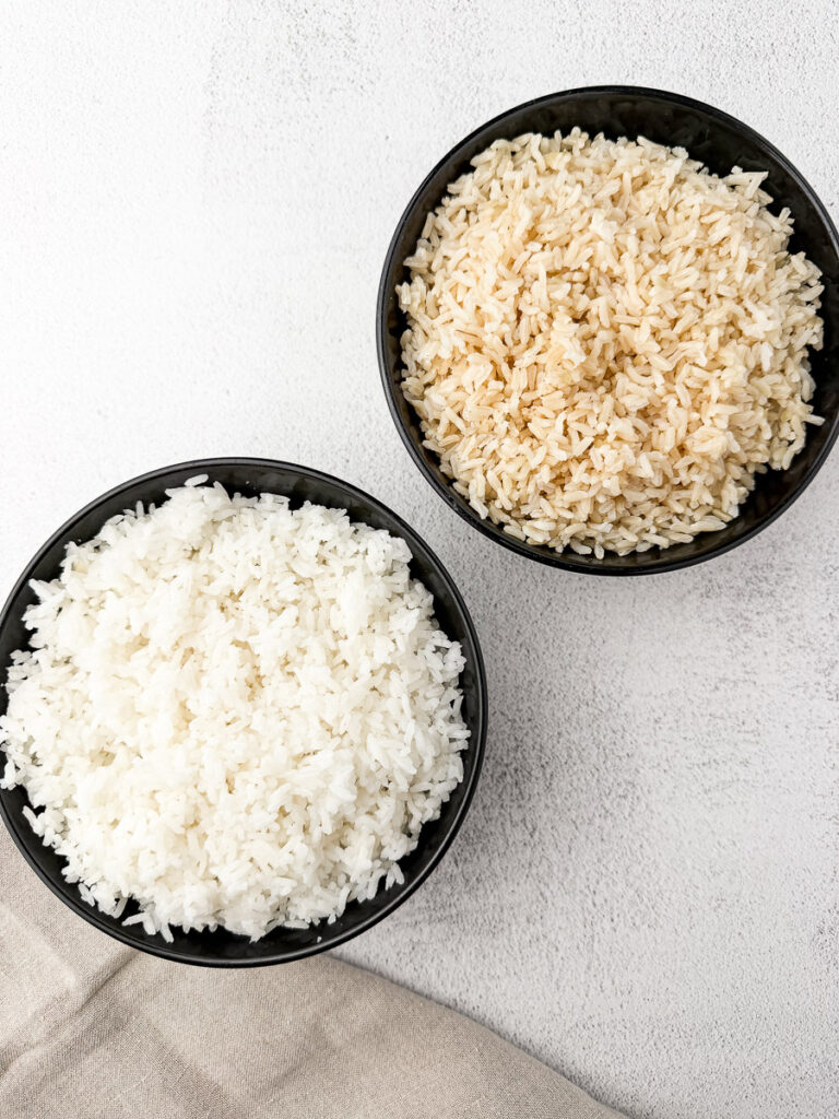 white rice and brown rice in black bowls