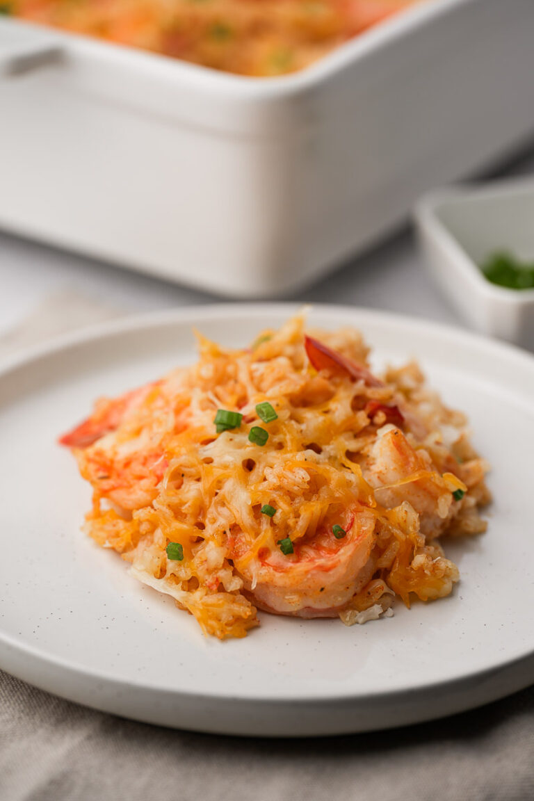 shrimp and rice casserole in a plat with pan in background