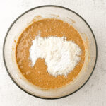 Healthy Almond Butter Banana Chocolate Chip Muffins with coconut flour on top