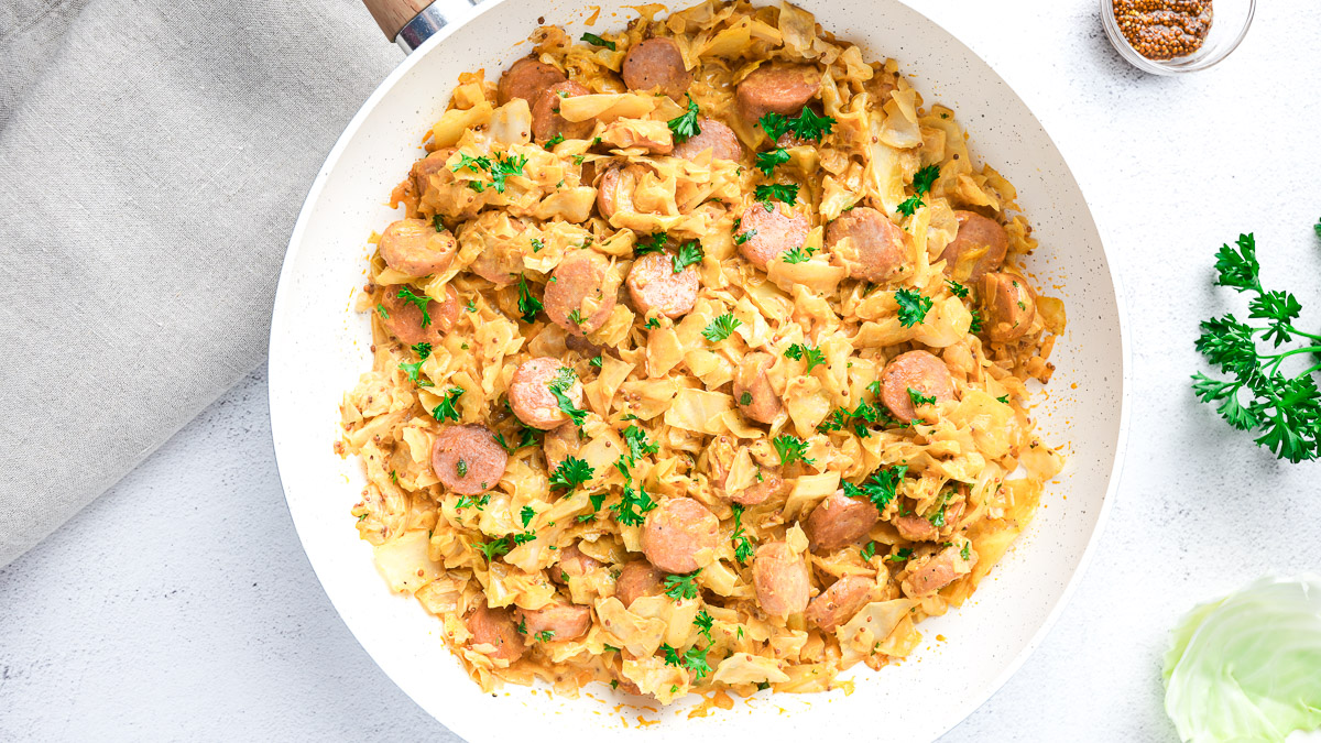 creamy cabbage and kielbasa skillet on table