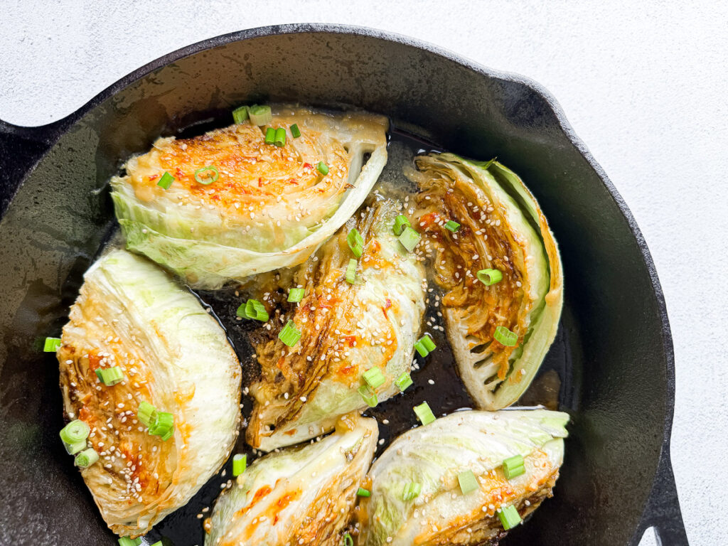 Pan-Seared Cabbage Wedges with Miso-Honey Glaze 10 pan-seared cabbage wedges with miso sauce in cast iron skillet
