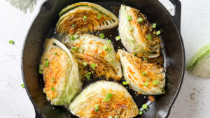 garnished with sesame seeds and parsley cabbage wedges with miso-honey sauce cooked in beef tallow in cast iron skillet
