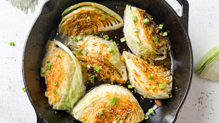 Pan-Seared Cabbage Wedges with Miso-Honey Glaze 16 garnished with sesame seeds and parsley cabbage wedges with miso-honey sauce cooked in beef tallow in cast iron skillet