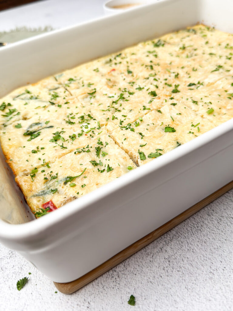 Easy Sausage and Egg Breakfast Casserole (No Bread!) 12 A 9x13 dish of Easy Sausage and Egg Breakfast Casserole No Bread sliced into fluffy squares for meal prep.