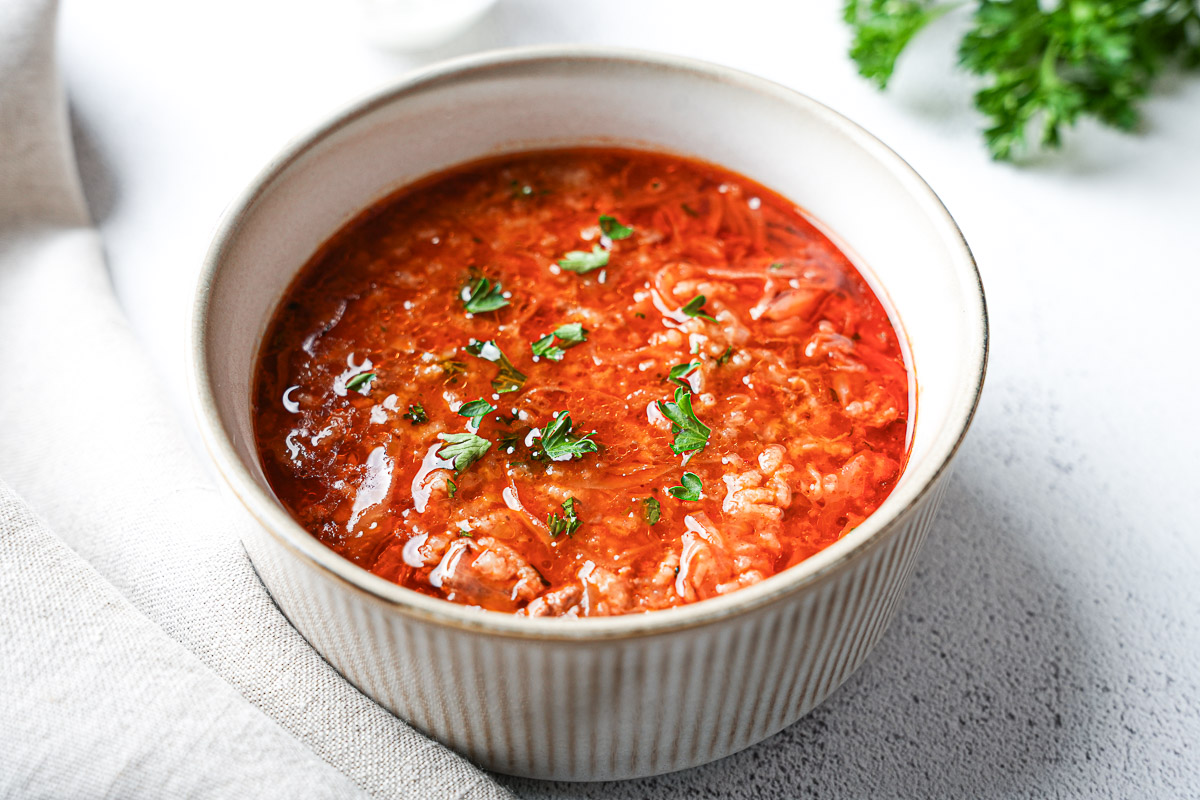 Deconstructed stuffed cabbage soup with ground beef, cabbage, and rice in a soup bowl