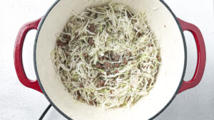 Deconstructed stuffed cabbage soup with ground beef, cabbage, and rice in a Dutch oven