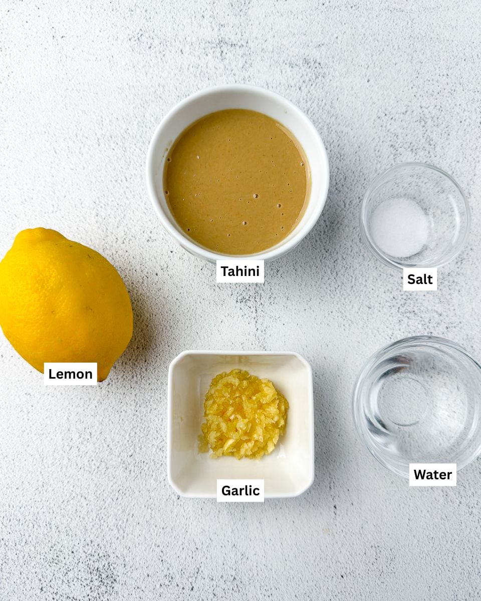 Creamy lemon tahini sauce ingredients: lemon, tahini, salt, minced garlic and water
