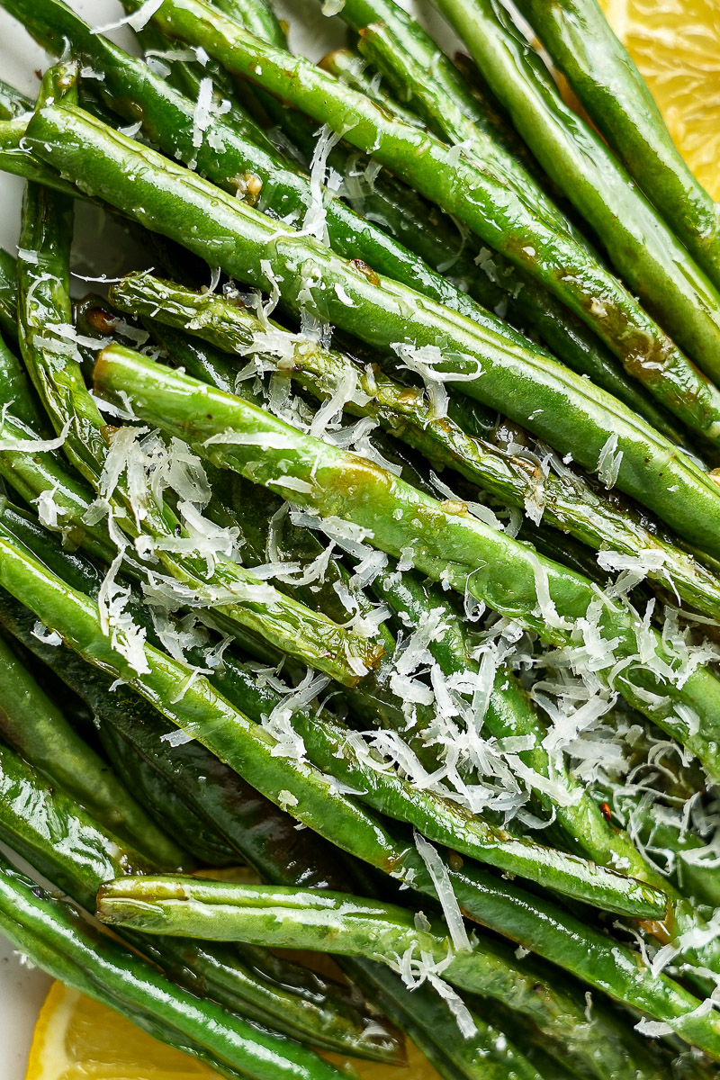Close-up of ghee garlic green beans with Parmesan on top