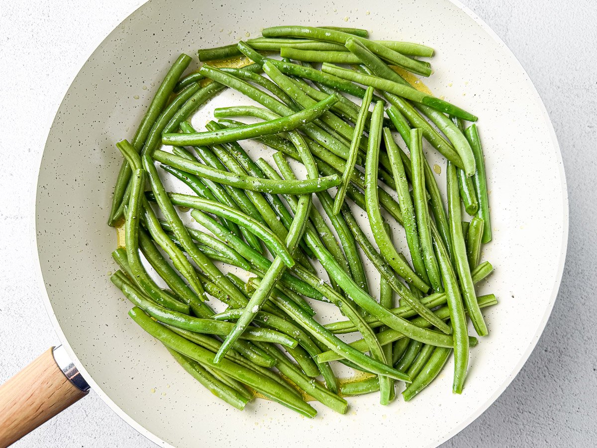 Sautéing Green Beans In Ghee Until Blistered And Golden Brown.