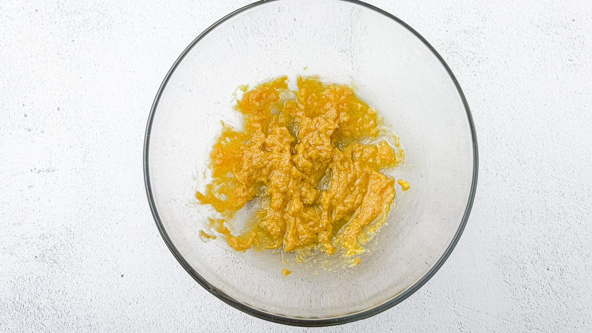 ginger with miso paste, maple syrup, rice vinegar and olive oil in a glass bowl