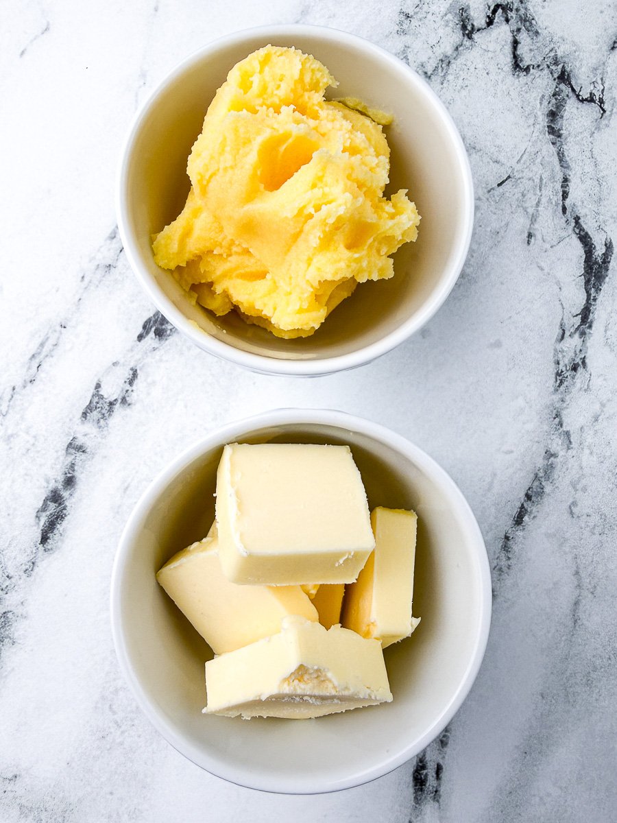 ghee vs butter in white bowls on countertop