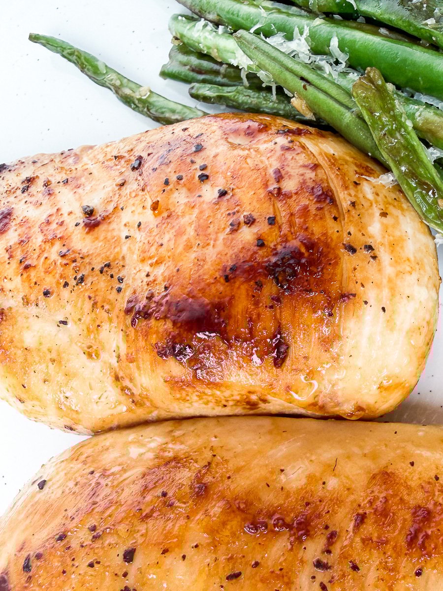 pan seared chicken breast with green beans in plate