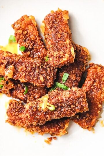 Copycat Chillis Nashville hot Mozzarella Sticks on white plate.